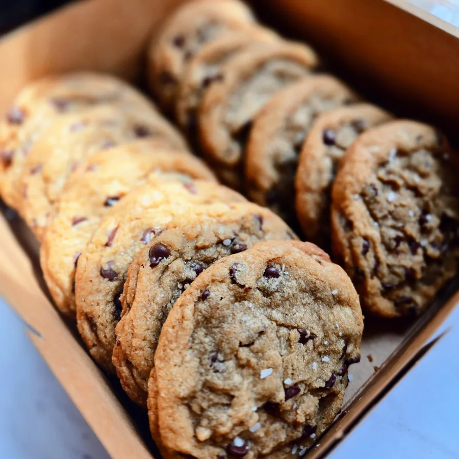 Chocolate chip cookies lined up in a box