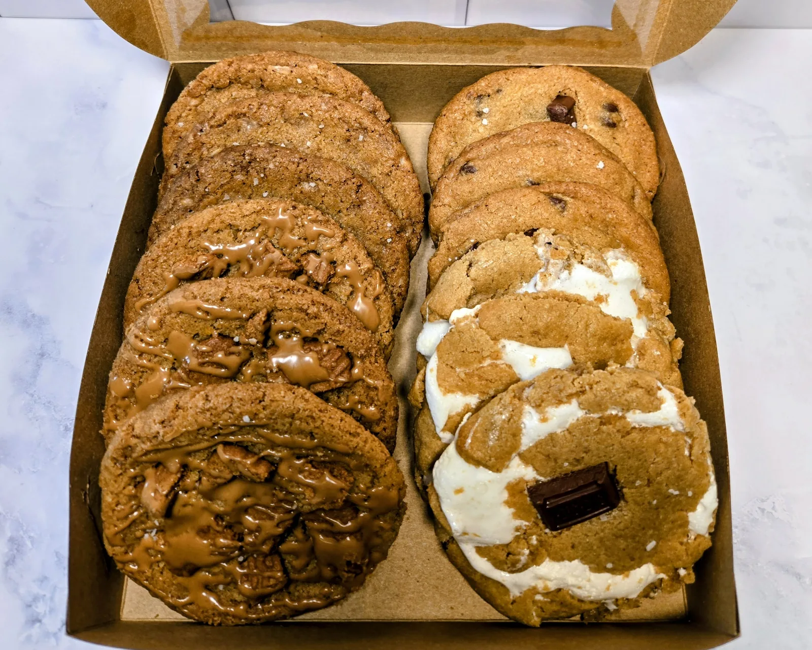 An open box of a dozen assorted cookies