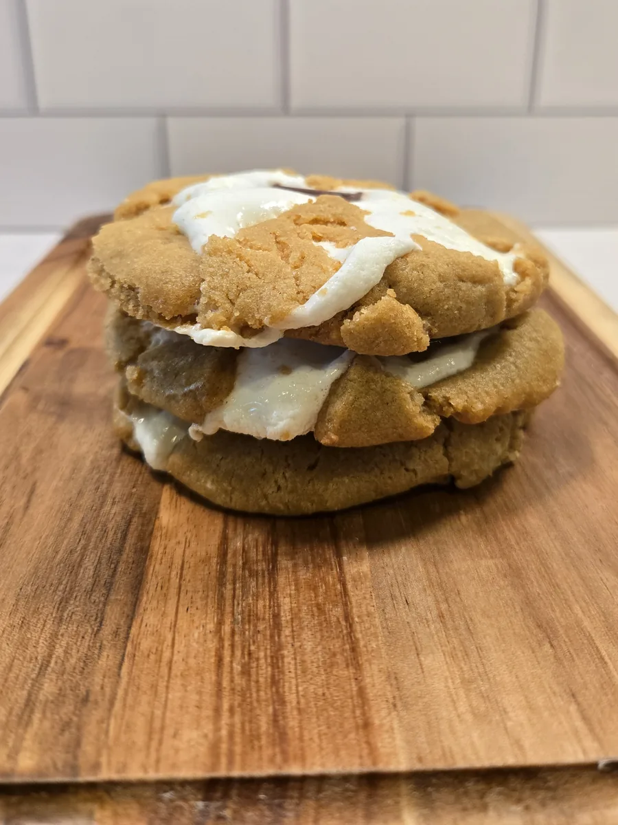 A stack of s’mores cookies on a wooden board