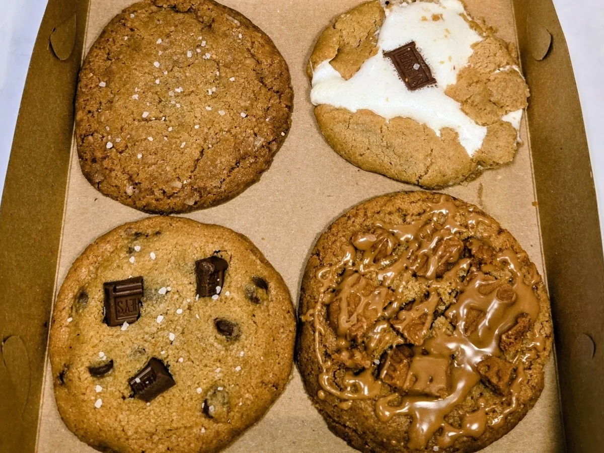 An open box of four assorted cookies